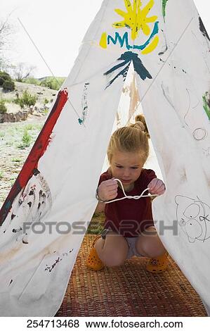 Girl tying knot of a tent, Santa Fe, New Mexico, USA View Large Photo Image Stock Photo - Girl tying knot of a tent, Santa Fe, New Mexico, USA. Fotosearch