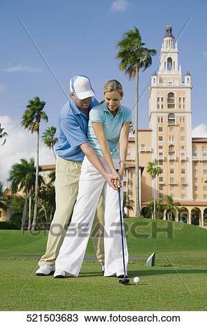 Golf instructor teaching golf to a woman, Biltmore Golf Course, Biltmore Hotel, Coral Gables, Florida, USA View Large Photo Image Stock Image - Golf instructor teaching golf to a woman, Biltmore Golf Course, Biltmore Hotel, Coral Gables, Florida, USA. Fotosearch