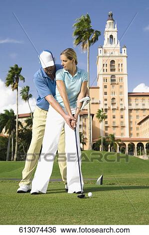 Golf instructor teaching golf to a woman, Biltmore Golf Course, Biltmore Hotel, Coral Gables, Florida, USA View Large Photo Image Stock Photograph - Golf instructor teaching golf to a woman, Biltmore Golf Course, Biltmore Hotel, Coral Gables, Florida, USA. Fotosearch