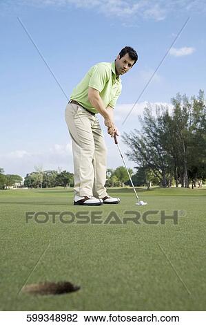 Golfer playing golf in a golf course, Biltmore Golf Course, Coral Gables, Florida, USA View Large Photo Image Stock Image - Golfer playing golf in a golf course, Biltmore Golf Course, Coral Gables, Florida, USA. Fotosearch