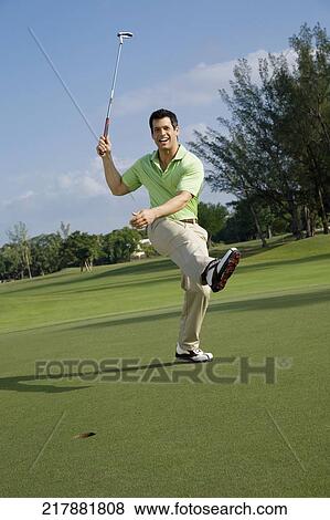Golfer playing golf in a golf course and smiling, Biltmore Golf Course, Coral Gables, Florida, USA View Large Photo Image Stock Photo - Golfer playing golf in a golf course and smiling, Biltmore Golf Course, Coral Gables, Florida, USA. Fotosearch