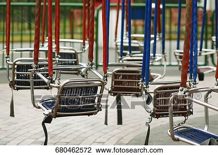 Hanging chairs in an amusement park ride View Large Photo Image Stock Image - Hanging chairs in an amusement park ride. Fotosearch