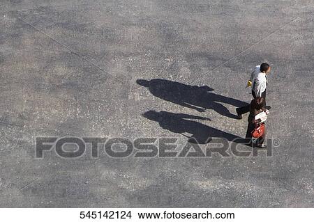 High angle view of a businessman and a businesswoman walking View Large Photo Image Picture - High angle view of a businessman and a businesswoman walking. Fotosearch