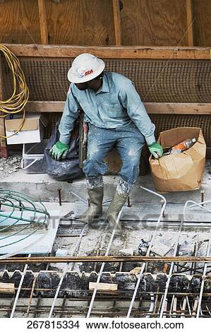 Picture - High angle view of a construction worker working at a construction site. Fotosearch