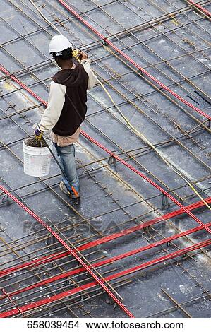 High angle view of a construction worker working at a construction site View Large Photo Image Picture - High angle view of a construction worker working at a construction site. Fotosearch