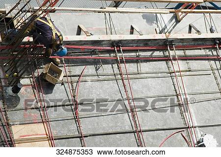 High angle view of a construction worker working at a construction site View Large Photo Image Stock Image - High angle view of a construction worker working at a construction site. Fotosearch