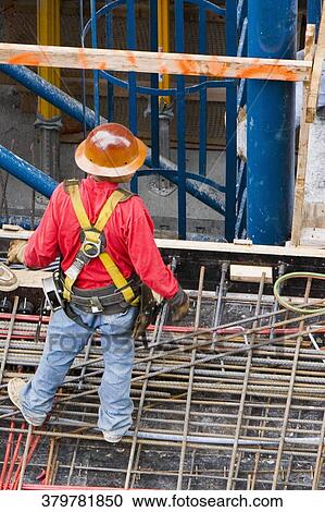 High angle view of a construction worker standing at a construction site View Large Photo Image Stock Image - High angle view of a construction worker standing at a construction site. Fotosearch