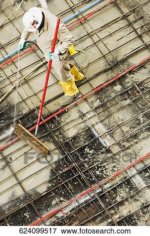 Stock Photo - High angle view of a construction worker working at a construction site. Fotosearch