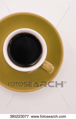 High angle view of a cup of black coffee on a saucer View Large Photo Image Stock Photo - High angle view of a cup of black coffee on a saucer. Fotosearch