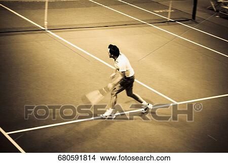 High angle view of a man playing tennis in a court View Large Photo Image Picture - High angle view of a man playing tennis in a court. Fotosearch