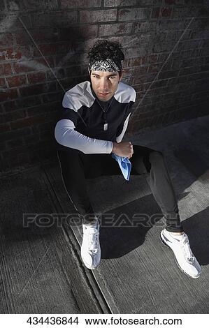 Picture - High angle view of a man resting after exercise. Fotosearch