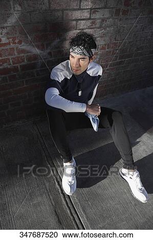 High angle view of a man resting after exercise View Large Photo Image Stock Image - High angle view of a man resting after exercise. Fotosearch