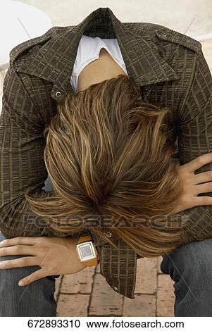 High angle view of a man sitting with his head down View Large Photo Image Stock Image - High angle view of a man sitting with his head down. Fotosearch