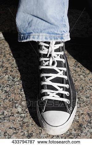 High angle view of a person's leg wearing canvas shoe View Large Photo Image Stock Photo - High angle view of a person's leg wearing canvas shoe. Fotosearch