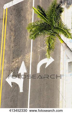 Stock Image - High angle view of arrow signs on the road. Fotosearch