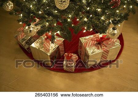 High angle view of Christmas presents under a Christmas tree View Large Photo Image Stock Photograph - High angle view of Christmas presents under a Christmas tree. Fotosearch