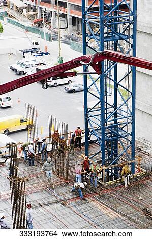 High angle view of construction workers working at a construction site View Large Photo Image Picture - High angle view of construction workers working at a construction site. Fotosearch