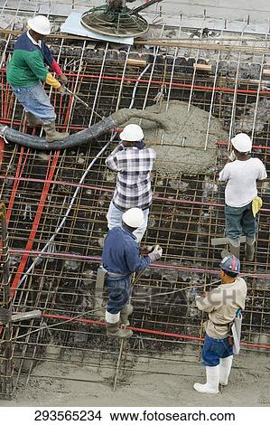 Picture - High angle view of five construction workers working at a construction site. Fotosearch