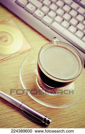 High angle view of tea cup and a computer keyboard with a cd case View Large Photo Image Stock Image - High angle view of tea cup and a computer keyboard with a cd case. Fotosearch