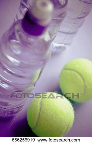 High angle view of three water bottles and two tennis balls View Large Photo Image Stock Photo - High angle view of three water bottles and two tennis balls. Fotosearch
