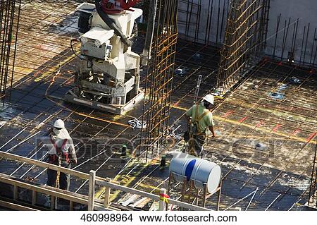 High angle view of two construction workers working at a construction site View Large Photo Image Picture - High angle view of two construction workers working at a construction site. Fotosearch