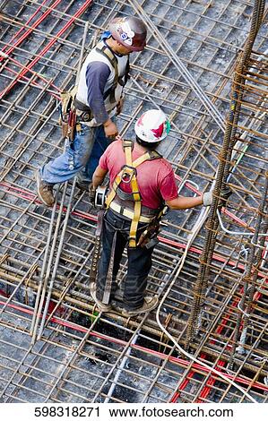 High angle view of two construction workers working at a construction site View Large Photo Image Stock Image - High angle view of two construction workers working at a construction site. Fotosearch