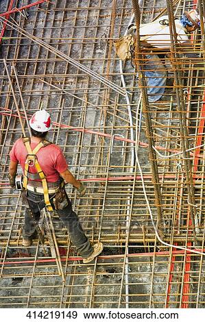 High angle view of two construction workers working at a construction site View Large Photo Image Stock Photo - High angle view of two construction workers working at a construction site. Fotosearch