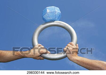 Homosexual couple's hands holding a large wedding ring, Washington DC, USA View Large Photo Image Picture - Homosexual couple's hands holding a large wedding ring, Washington DC, USA. Fotosearch