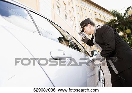Hotel porter adjusting his cap, Biltmore Hotel, Coral Gables, Florida, USA View Large Photo Image Stock Photograph - Hotel porter adjusting his cap, Biltmore Hotel, Coral Gables, Florida, USA. Fotosearch