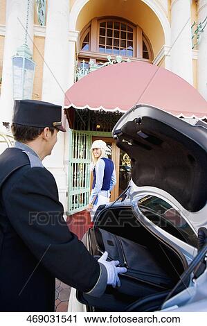Hotel porter carrying luggage from a car, Biltmore Hotel, Coral Gables, Florida, USA View Large Photo Image Stock Image - Hotel porter carrying luggage from a car, Biltmore Hotel, Coral Gables, Florida, USA. Fotosearch