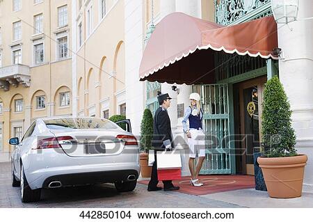 Hotel porter carrying luggage of a woman, Biltmore Hotel, Coral Gables, Florida, USA View Large Photo Image Picture - Hotel porter carrying luggage of a woman, Biltmore Hotel, Coral Gables, Florida, USA. Fotosearch