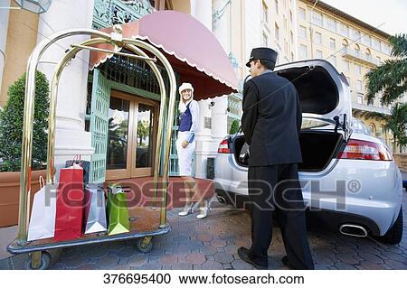 Hotel porter carrying luggage of a woman, Biltmore Hotel, Coral Gables, Florida, USA View Large Photo Image Stock Image - Hotel porter carrying luggage of a woman, Biltmore Hotel, Coral Gables, Florida, USA. Fotosearch