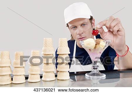 Ice cream seller holding a cherry View Large Photo Image Stock Image - Ice cream seller holding a cherry. Fotosearch