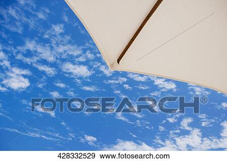 Low angle view of a beach umbrella View Large Photo Image Stock Photo - Low angle view of a beach umbrella. Fotosearch