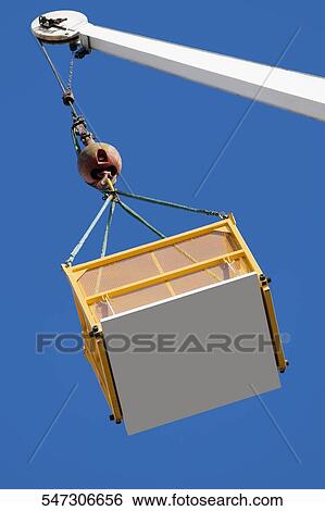 Low angle view of a crane picking up a box View Large Photo Image Stock Photograph - Low angle view of a crane picking up a box. Fotosearch