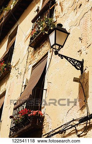 Stock Photo - Low angle view of a lantern on a wall. Fotosearch