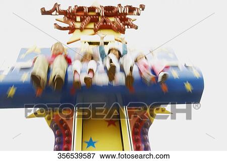 Low angle view of boys and girls on an amusement park ride View Large Photo Image Stock Photo - Low angle view of boys and girls on an amusement park ride. Fotosearch