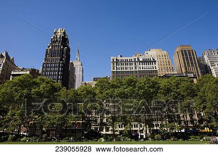 Low angle view of buildings in a city, Empire State Building, Manhattan, Bryant Park, New York City, New York State, USA View Large Photo Image Stock Photo - Low angle view of buildings in a city, Empire State Building, Manhattan, Bryant Park, New York City, New York State, USA. Fotosearch