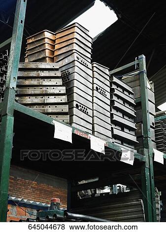 Low angle view of stacks of metal objects on a rack View Large Photo Image Stock Photo - Low angle view of stacks of metal objects on a rack. Fotosearch