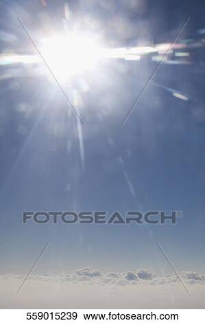 Stock Photo - Low angle view of the sun shining in the sky. Fotosearch