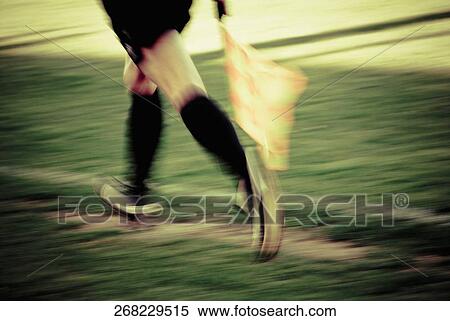 Low section view of a lineman running with a flag View Large Photo Image Stock Photography - Low section view of a lineman running with a flag. Fotosearch