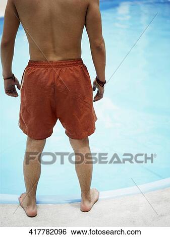 Low section view of a man standing at the poolside View Large Photo Image Stock Photograph - Low section view of a man standing at the poolside. Fotosearch