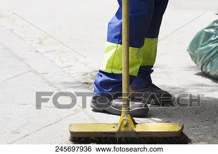 Low section view of a street sweeper with a broom, Madrid, Spain View Large Photo Image Stock Photograph - Low section view of a street sweeper with a broom, Madrid, Spain. Fotosearch