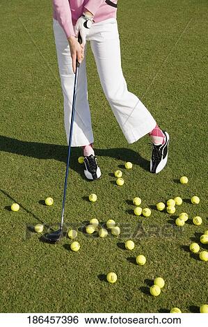 Stock Photograph - Low section view of a woman playing golf, Biltmore Golf Course, Coral Gables, Florida, USA. Fotosearch