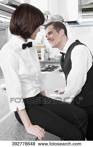 Male and a female waiters smiling at each other View Large Photo Image Stock Photo - Male and a female waiters smiling at each other. Fotosearch