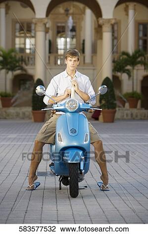 Man adjusting his tie and sitting on a moped, Biltmore Hotel, Coral Gables, Florida, USA View Large Photo Image Stock Image - Man adjusting his tie and sitting on a moped, Biltmore Hotel, Coral Gables, Florida, USA. Fotosearch
