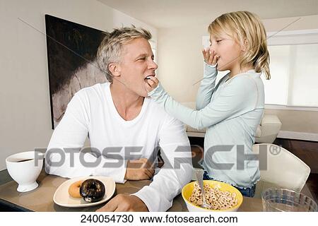 Man and his daughter having breakfast View Large Photo Image Stock Image - Man and his daughter having breakfast. Fotosearch