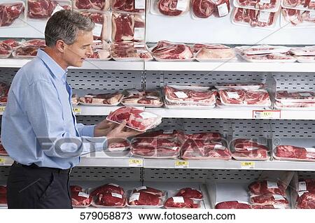 Man choosing a meat packed View Large Photo Image Stock Image - Man choosing a meat packed. Fotosearch