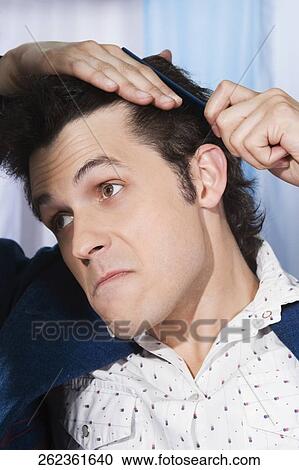 Man combing his hair View Large Photo Image Stock Image - Man combing his hair. Fotosearch