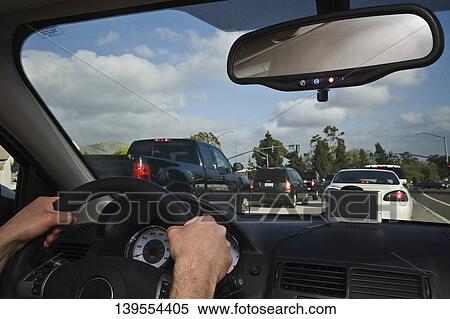 Stock Photography - Man driving a car on the highway. Fotosearch
